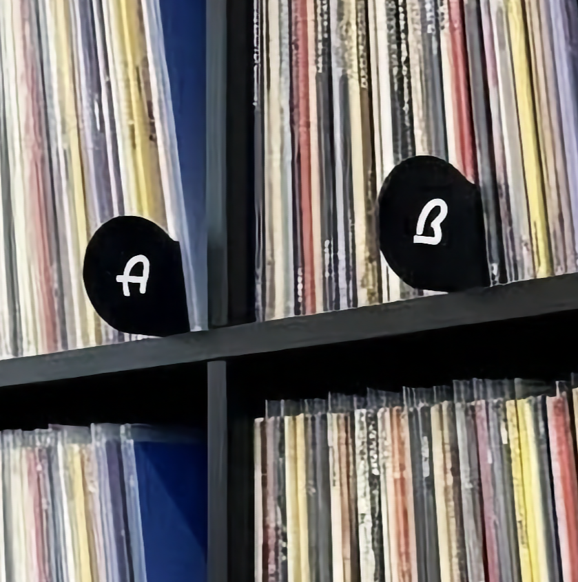 Close‑up detail photo of Classic A–Z Mid‑Century Modern vinyl record dividers showing matte black finish and letter cutouts