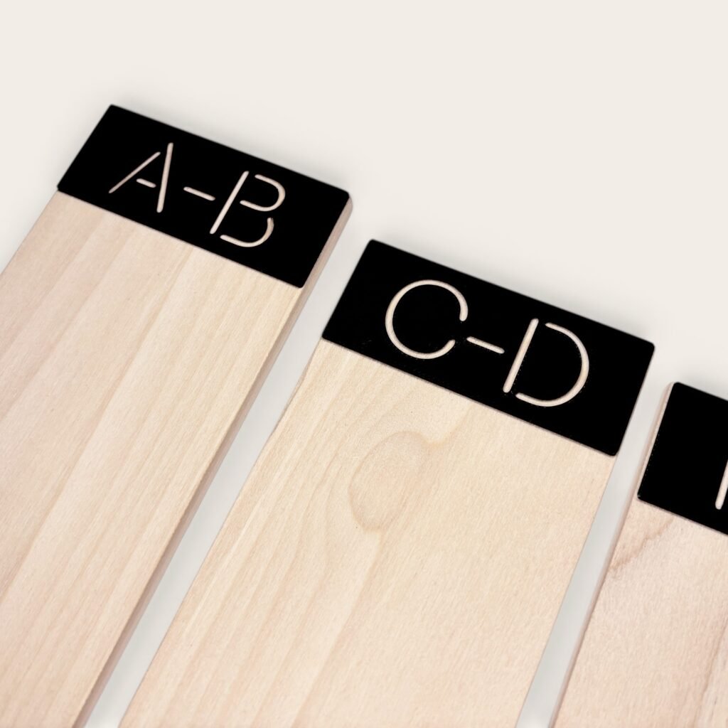 Wooden alphabetical vinyl record dividers featuring black tabs labeled A-B and C-D.