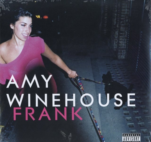 Amy Winehouse smiling in a pink top walking a dog on her Frank album cover.