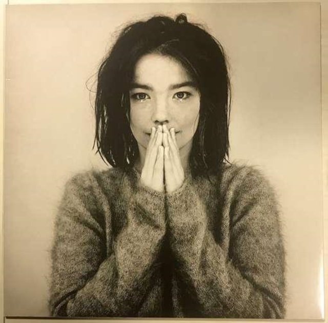 Black-and-white portrait of singer Björk in a fuzzy sweater for her Debut album cover.