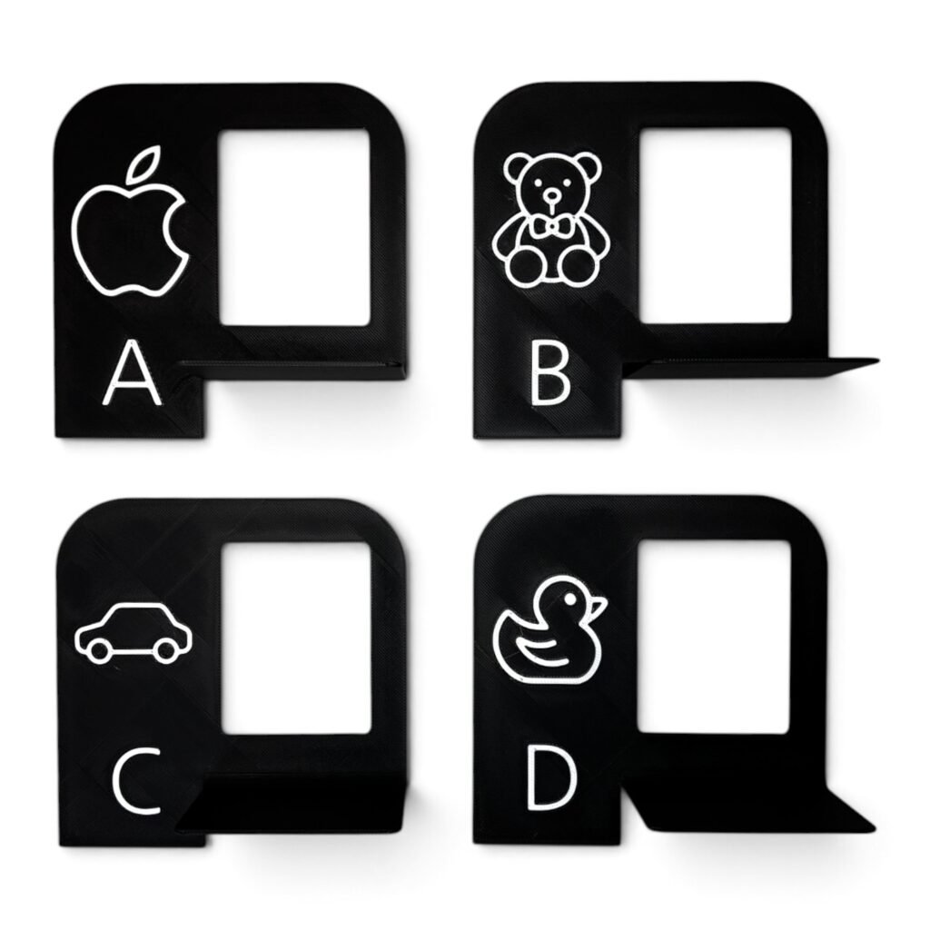 Set of four black nursery wall photo shelves with picture frames and ledges.