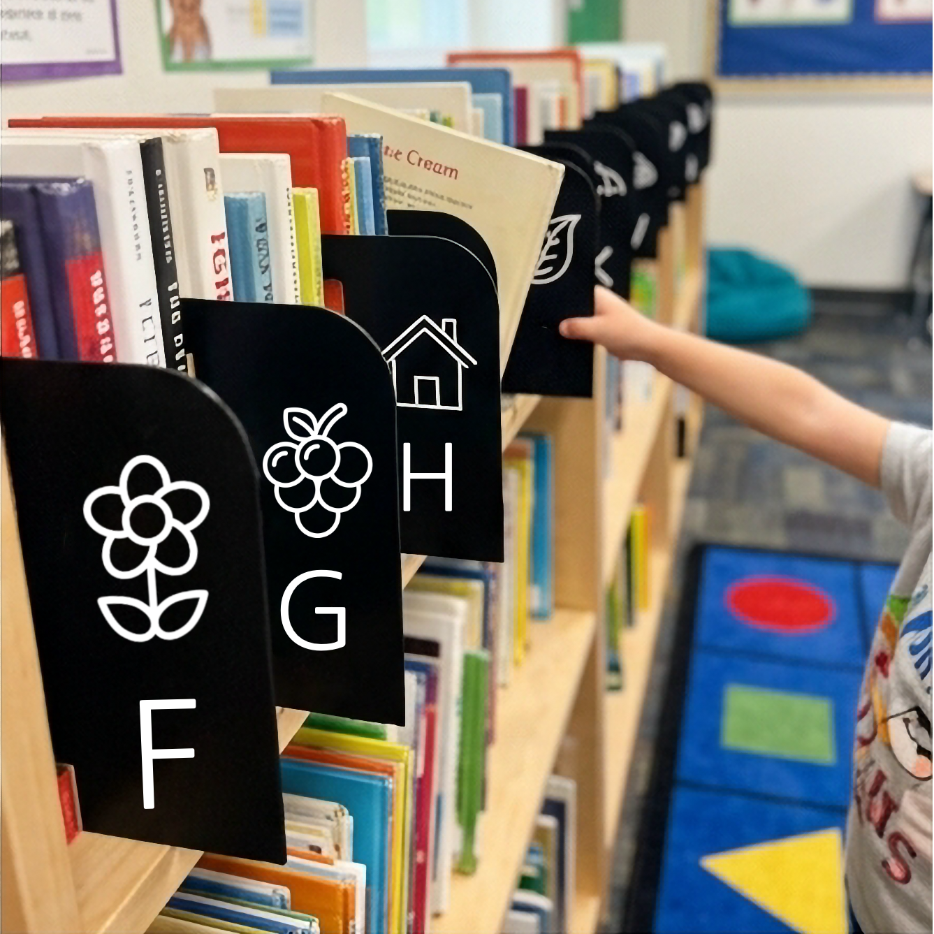 1 Hero Organized classroom bookshelf with custom black alphabet dividers and childrens books.