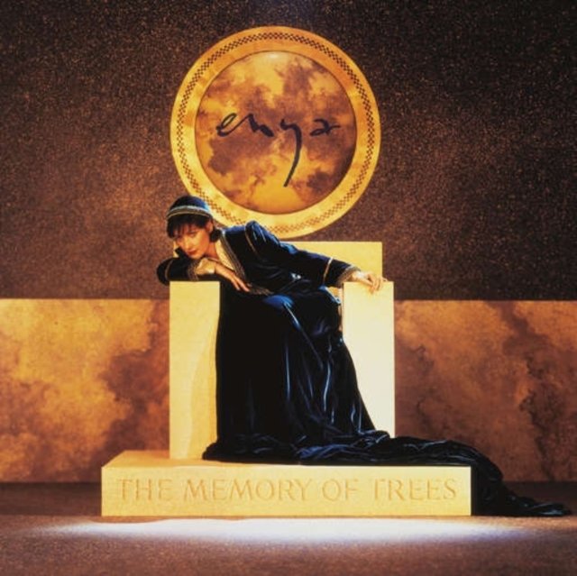 Enya in a blue gown on a stone throne, The Memory of Trees album cover.