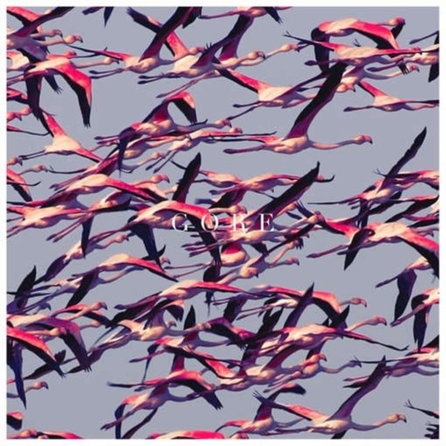 A dense flock of vibrant pink flamingos flying across a pale sky.