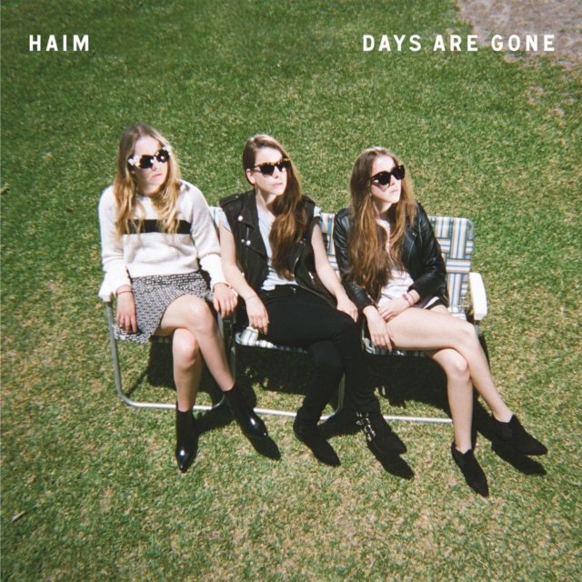 HAIMs Days Are Gone album cover featuring the three sisters on a lawn bench.