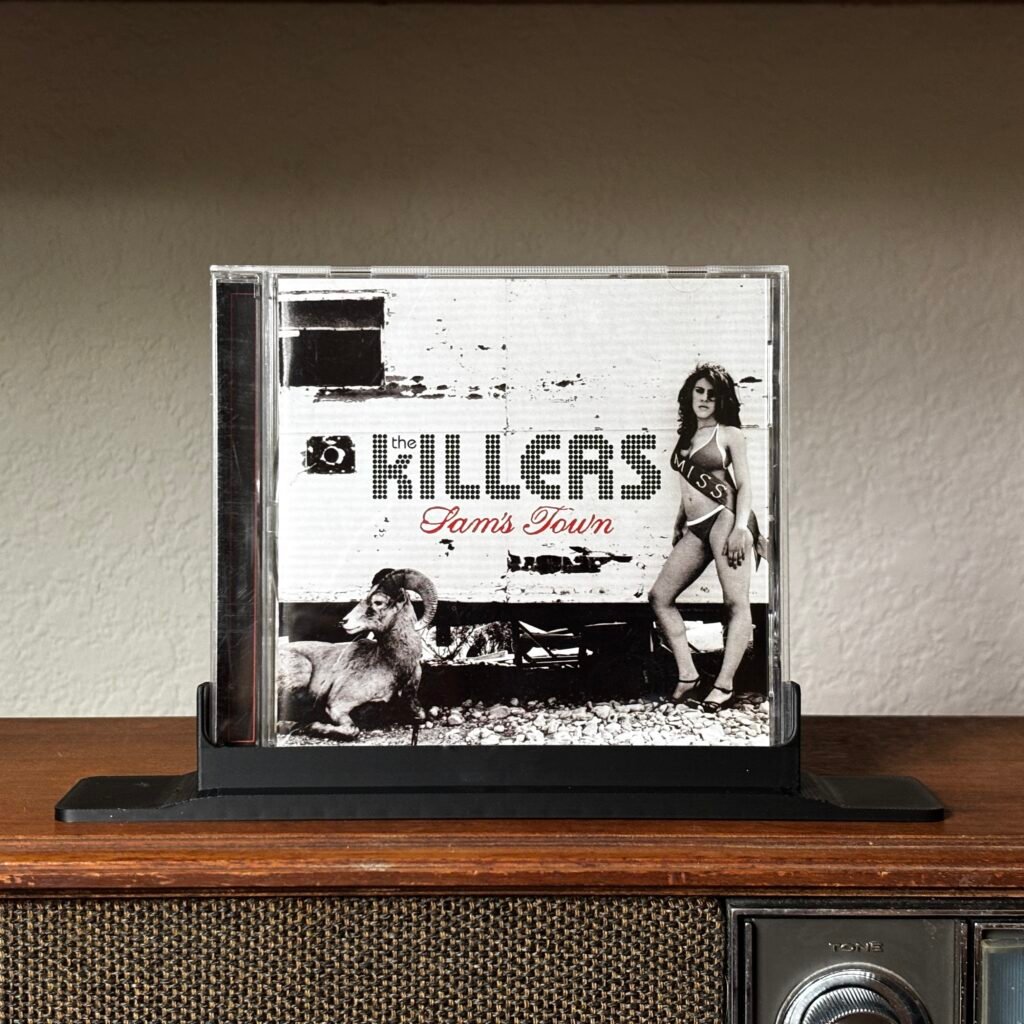 The Killers Sams Town album CD jewel case on a vintage wooden stereo.