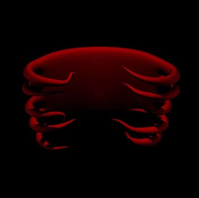 Red abstract sculpture resembling a stylized ribcage against a pitch-black background.