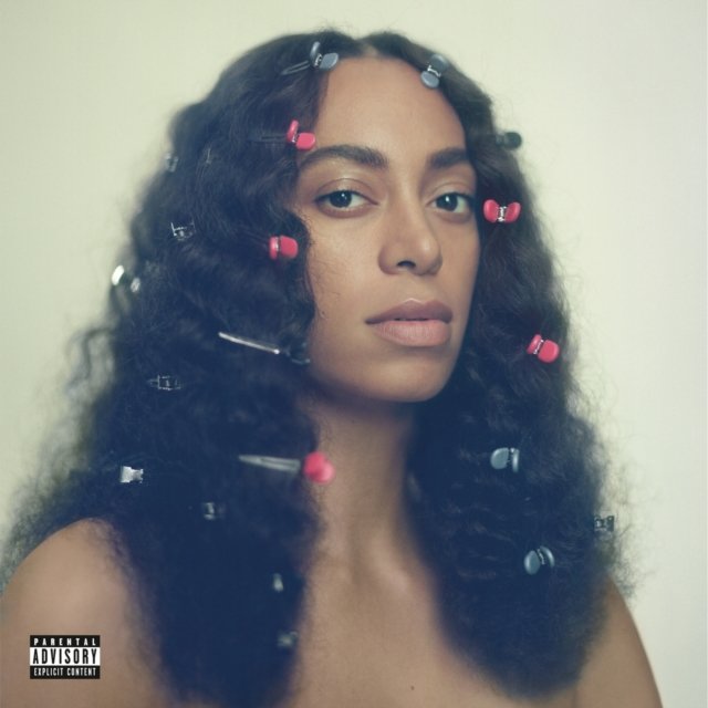 Solange Knowles album cover for A Seat at the Table featuring colorful hair clips.