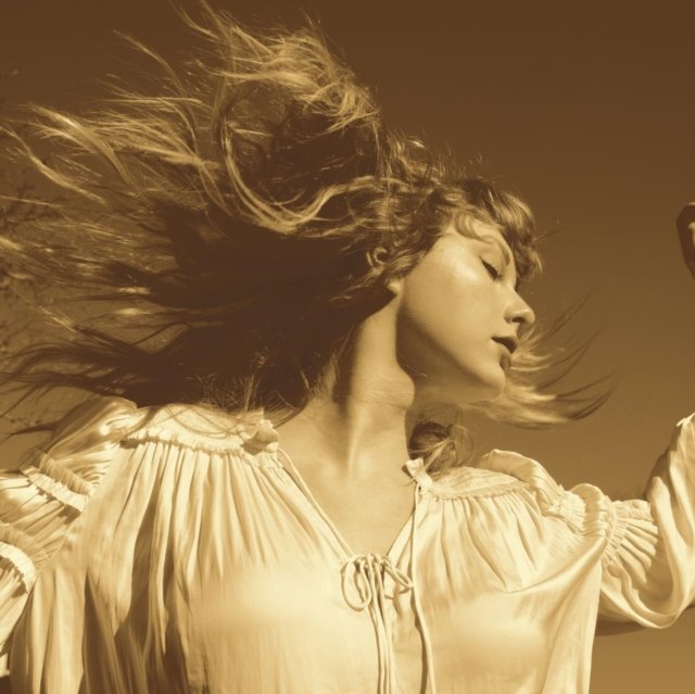 Taylor Swift with dramatic windblown hair on the Fearless (Taylors Version) album cover.