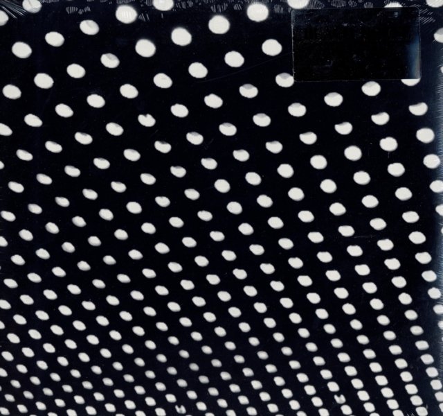 Angled perspective view of a white polka dot pattern receding on a black background.
