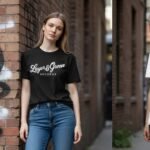 Woman wearing a black graphic t-shirt and blue jeans in an urban brick alley.