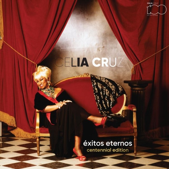 Album cover for Celia Cruzs Éxitos Eternos featuring her on a red velvet couch.