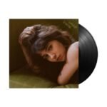 Clairo Charm vinyl record album with black LP disc slipping out of sleeve.