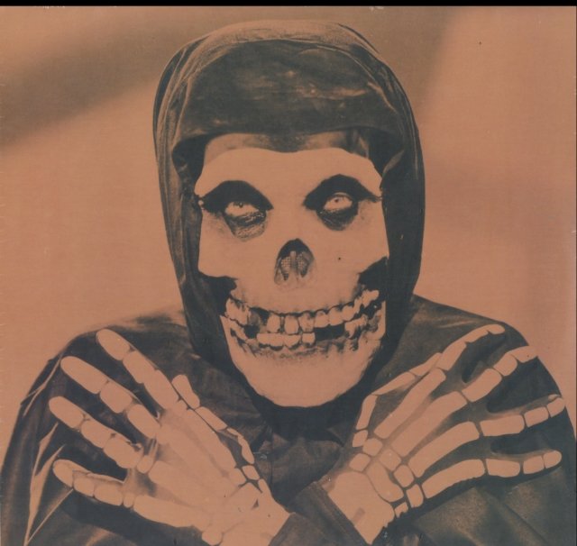0017046751513.jpg Sepia portrait of the Crimson Ghost wearing a skull mask and skeletal gloves.