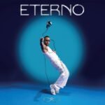 ETERNO album cover featuring a male artist in white posing under a floating microphone.