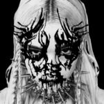 Black-and-white gothic portrait featuring dark face paint, blonde braids, and a spiked collar.