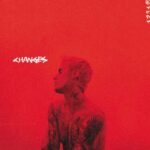 Justin Biebers Changes album cover featuring a red duotone profile portrait with tattoos.
