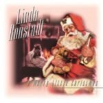 Album cover for Linda Ronstadts A Merry Little Christmas featuring Santa Claus holding toys.