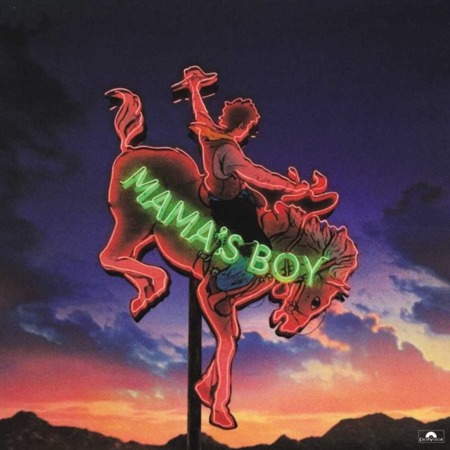 Vintage Mamas Boy neon sign of a cowboy riding a bucking bronco at sunset.