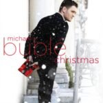 Michael Bublé’s Christmas album cover, featuring him holding a red gift in the snow.