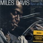 Miles Davis Kind of Blue vinyl album cover in a protective plastic sleeve.
