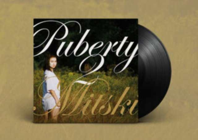 Mitskis Puberty vinyl album cover and black record on a neutral background.