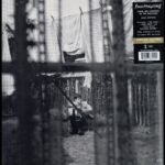 Paul McCartneys Chaos and Creation in the Backyard album cover featuring young McCartney playing guitar.
