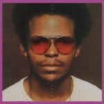 Album cover for Ronnie Fosters Two Headed Freak featuring a portrait wearing red sunglasses.