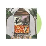 Lime green vinyl record emerging from an album cover featuring a burning house.