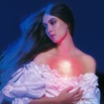 Ethereal portrait of a woman in a vintage gown with a glowing pink chest.